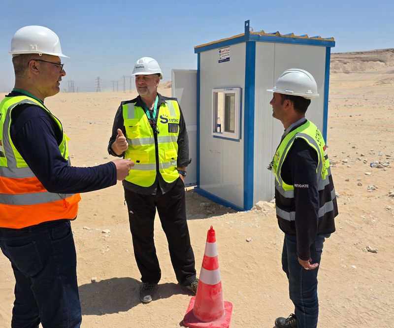 Security team talking beside a guard cabin on site