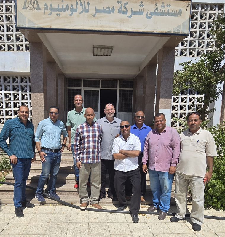 Project team members gathered on the steps of a site building